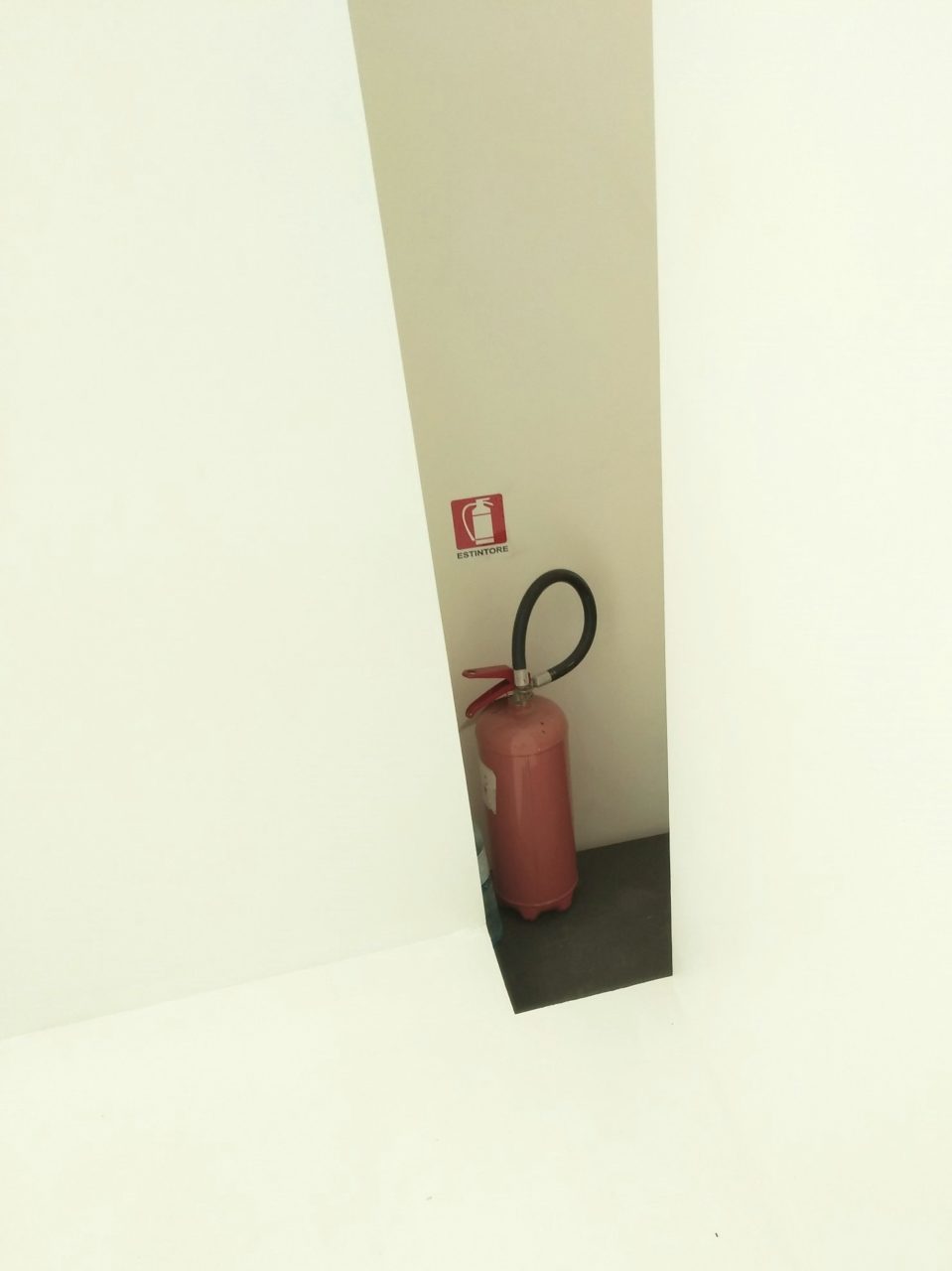 Untitled 480, metal and plastic fire extinguisher with paper label, laminated estintore (fire extinguisher) sign, plastic water bottle, white emulsion, 2019, NFS